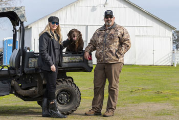 Rice dog and its owners on their farm