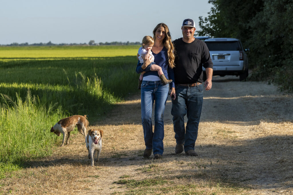 Tristan and Elise Nelson and their dog Callie Rose on their Pleasant Grove rice farm, Wednesday, July 31, 2019.
Photo Brian Baer