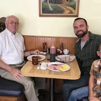 Logan Wilson with his father and son eating breakfast