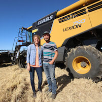 peter and carissa rystrom in front of harvester